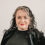 Elegant portrait of a confident woman with curly hair in Greenville, SC.